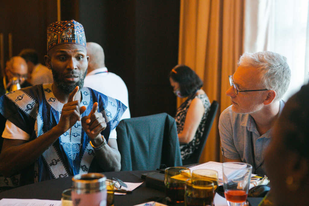 Sulayman Ujah, Disability Inclusion Advisor of CBM Global Nigeria, signs during the Inclusion Advisory Group (IAG) workshop in Manila. Sitting next to him is Sander Schot, Senior Inclusion Advisor of CBM Global.