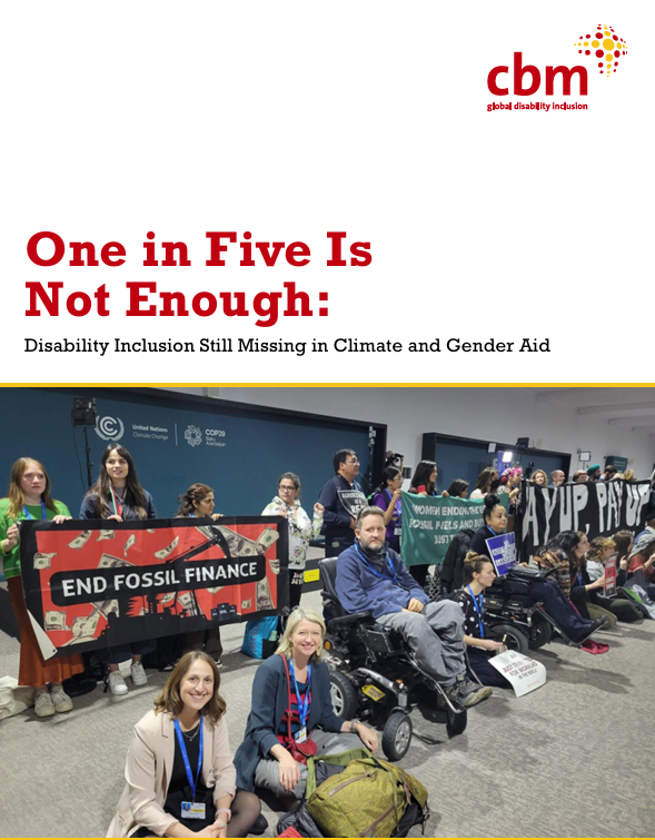 A group of disability rights activists, including wheelchair users, sit and stand together at a climate conference protest. They hold banners reading “End Fossil Finance” and other climate justice messages. The setting appears to be a COP event space. The cover text reads: “One in Five Is Not Enough: Disability Inclusion Still Missing in Climate and Gender Aid,” with the CBM Global Disability Inclusion logo at the top.